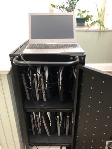 a black metal case housing 10 chromebook laptops