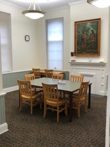 the study room features a small conference table seating six comfortably