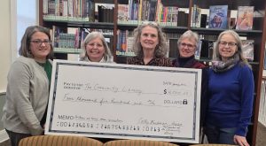 Image of Friends members presenting the Library Director and Trustees with a $4,500 check